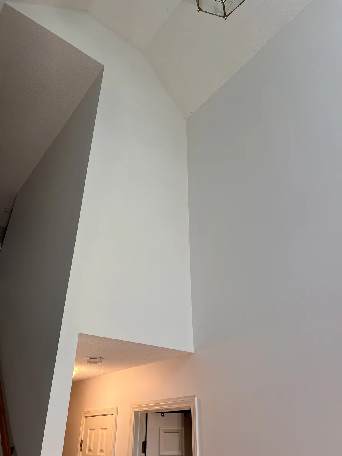 Painted tall walls beside the entryway staircase