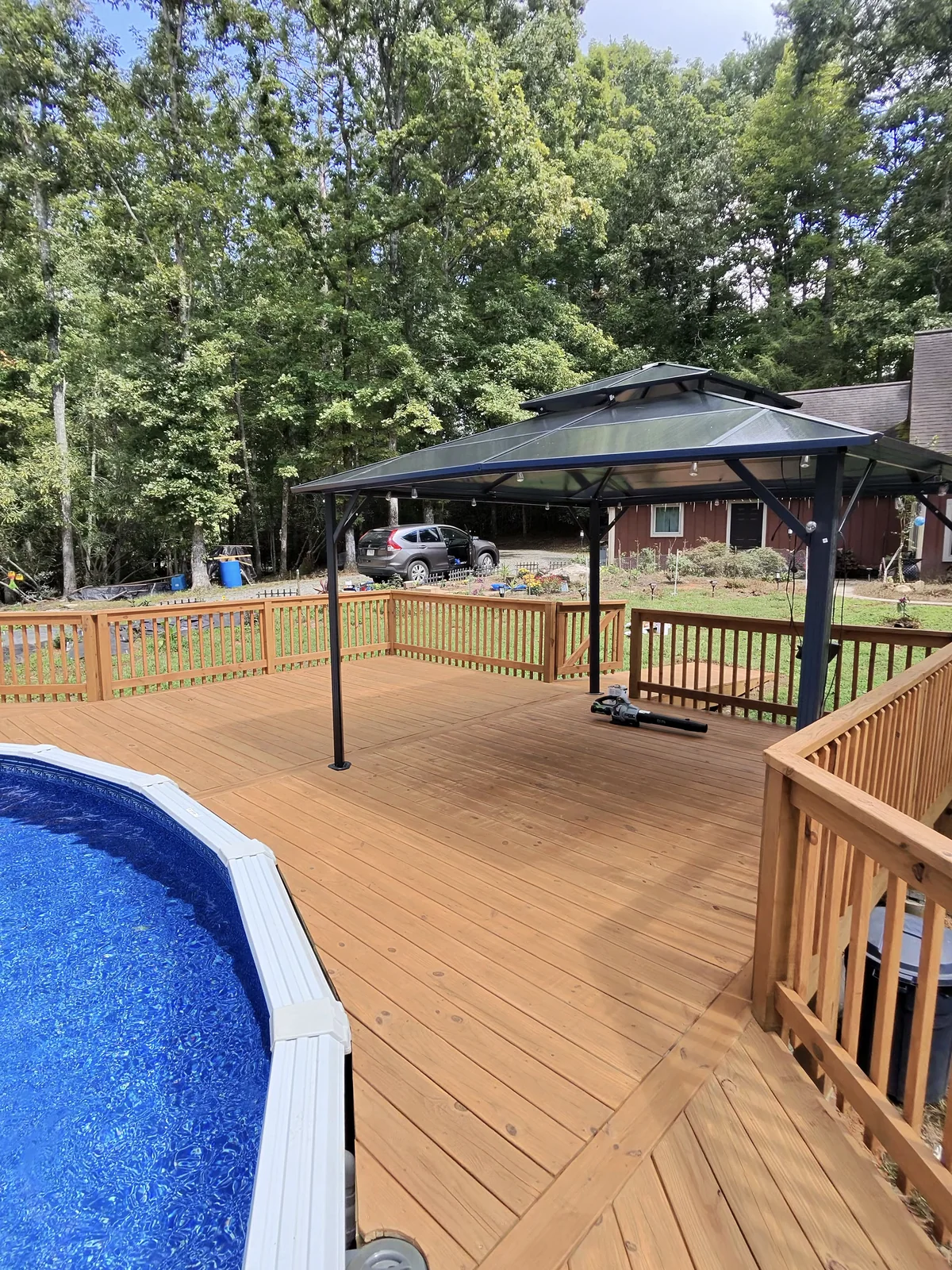 Refinished pool deck leading to a covered seating area in Hendersonville